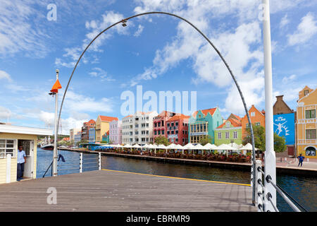 Colourful houses of Handelskade at Willemstad, view from the opened Queen Emma pontoon bridge, operator in door of shelter Stock Photo