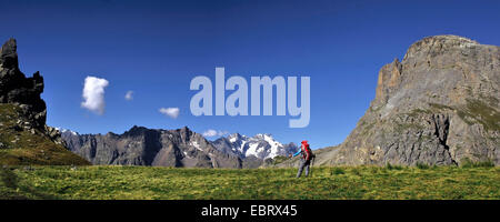 hiker woman at massif des cerces at mountain of Thabor, massif des Ecrins in the background, France, Savoie , Hautes-Alpes, Briancon Valloire Stock Photo