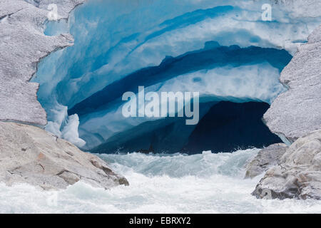 melt water leaking out of glacier snout of Nigardsbreen, a glacier arm of Jostedalsbreen glacier, Norway, Jostedalsbreen National Park Stock Photo