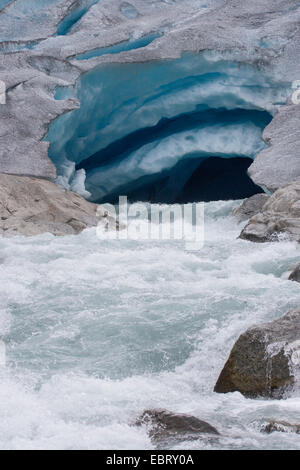 melt water leaking out of glacier snout of Nigardsbreen, a glacier arm of Jostedalsbreen glacier, Norway, Jostedalsbreen National Park Stock Photo