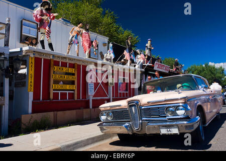 pink cadillac in front of souvenir shop decorated with display dummies, USA, Arizona, Seligman Stock Photo