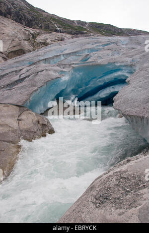 melt water leaking out of glacier snout of Nigardsbreen, a glacier arm of Jostedalsbreen glacier, Norway, Jostedalsbreen National Park Stock Photo