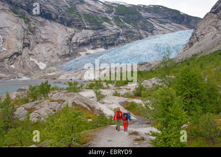 two children wandering to Nigardsbreen glacier arm, Norway, Jostedalsbreen National Park Stock Photo