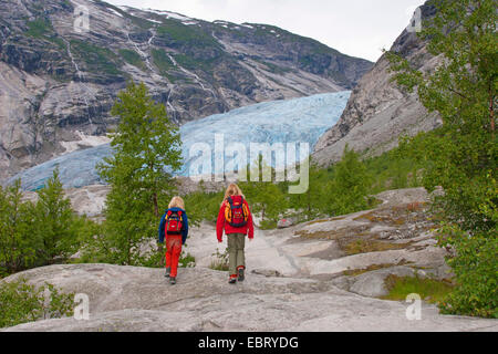 two children wandering to Nigardsbreen glacier arm, Norway, Jostedalsbreen National Park Stock Photo