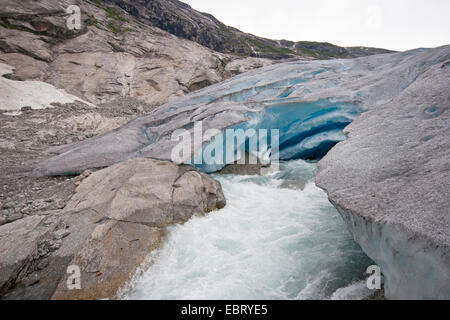 melt water leaking out of glacier snout of Nigardsbreen, a glacier arm of Jostedalsbreen glacier, Norway, Jostedalsbreen National Park Stock Photo