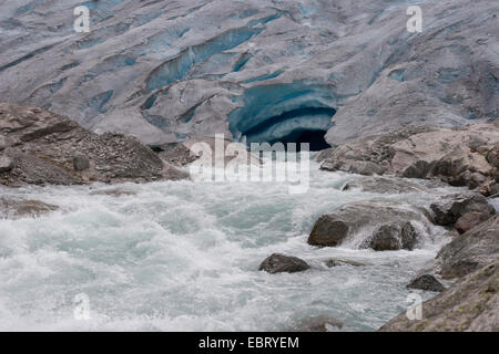 melt water leaking out of glacier snout of Nigardsbreen, a glacier arm of Jostedalsbreen glacier, Norway, Jostedalsbreen National Park Stock Photo