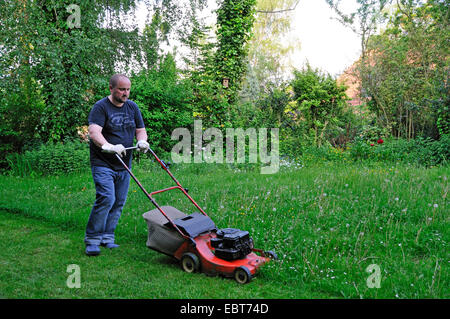 man mowing the lawn, Germany, Ruhr Area, Castrop-Rauxel Stock Photo