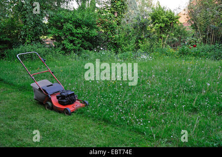 power mower standing in the garden, Germany, Ruhr Area, Castrop-Rauxel Stock Photo