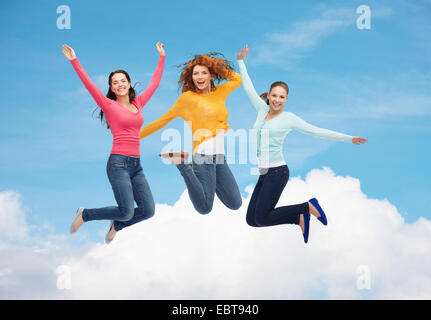 group of smiling young women jumping in air Stock Photo