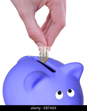 A woman hand putting a euro coin on a piggy bank Stock Photo - Alamy