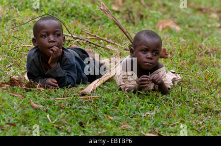 two boys lying in meadow, Uganda, Bwindi Stock Photo
