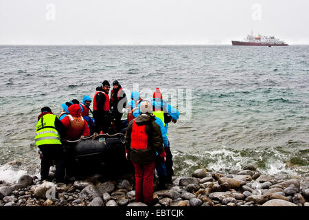 tourists with zodiak at the coast, cruise ship in background, Norway, Svalbard Stock Photo