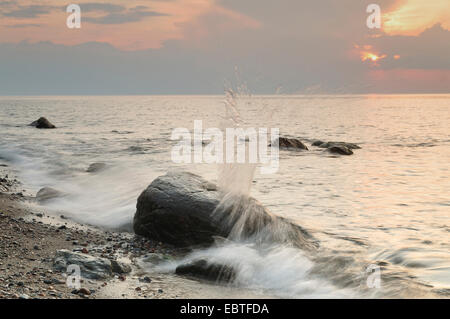 erratic boulders in the surf of the Baltic Sea at sunset, Germany, Mecklenburg-Western Pomerania Stock Photo