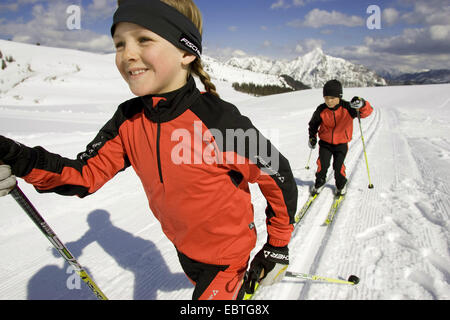 children cross-country skiing in the mountains, Austria Stock Photo