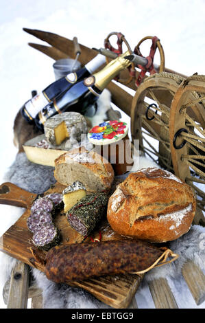 speciality cheese and sausages, foods from Alps mountains on toboggan, France Stock Photo