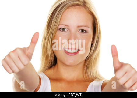 young, successful woman holds her thumbs up Stock Photo