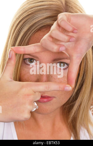 woman forming a frame of fingers Stock Photo