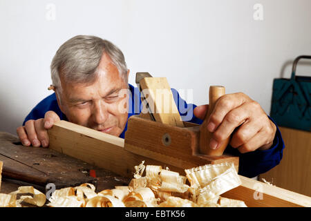 carpenter planing in his workshop Stock Photo