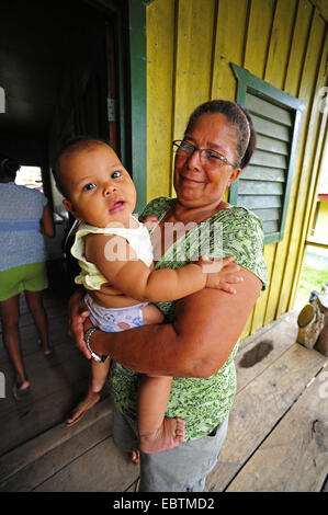 grandmother with her little grandchild on the arms, Honduras, Brus Laguna, Las Marias Stock Photo