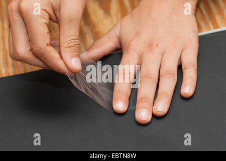 taking fingerprints. Step 5: the fingerprint fixed on a transparent cellotape is sticked on a black board Stock Photo
