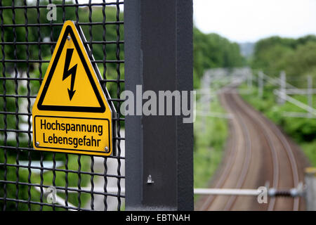 warning sign of high voltage over railroad line, Germany, North Rhine-Westphalia Stock Photo