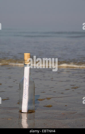 message in a bottle at sandy beach Stock Photo