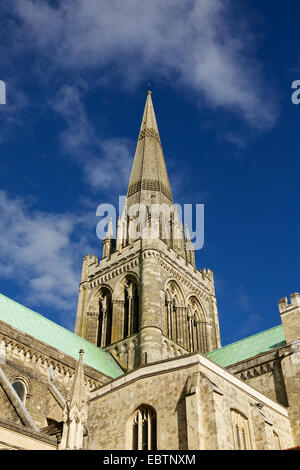 View looking up at the impressive steeple of Chichester Cathedral that is disappearing into a deep blue sky. Stock Photo