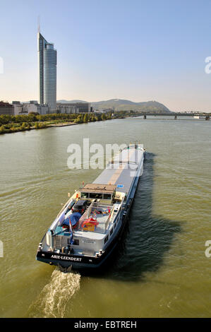 push boat on Danube, Millenium Tower of Vienna in background, Austria, Danube, Vienna Stock Photo