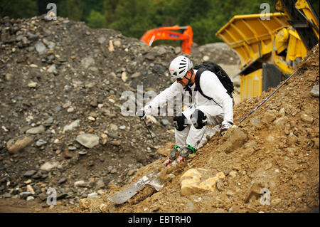 freeride skier in a quarry going downhill on rocky slope Stock Photo
