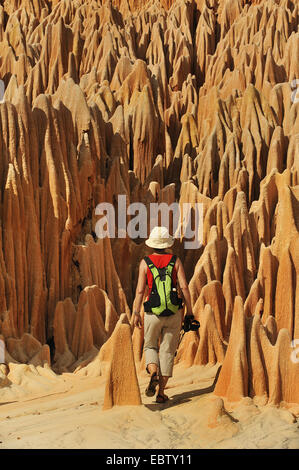 tourist in red karst limestone formation, Madagascar, Nationalpark Tsingy de Bemaraha, Tsingy Stock Photo