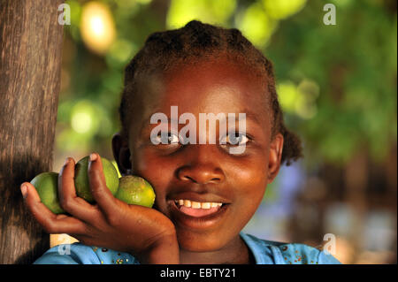 dark-skinned girl with citrus fruits, Madagascar, Nosy Be Stock Photo