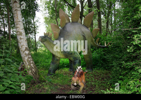 Stegosaurus (Stegosaurus), with juvenile in a forest Stock Photo