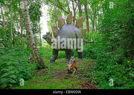 Stegosaurus (Stegosaurus), with juvenile in a forest Stock Photo