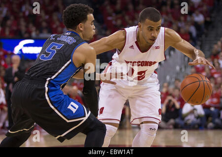 December 3, 2014: Duke Blue Devils guard Tyus Jones #5 applies pressure to Wisconsin Badgers guard Traevon Jackson #12 during the NCAA Basketball game between Duke Blue Devils and the Wisconsin Badgers at the Kohl Center in Madison, WI. Duke defeated Wisconsin 80-70. John Fisher/CSM. Stock Photo