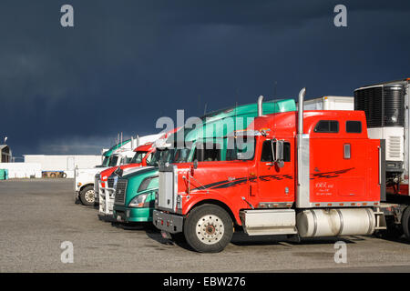 Semi trucks and dark storm clouds at Flying J Travel Plaza, Pasco, WA 99301, United States. truck stop. Stock Photo