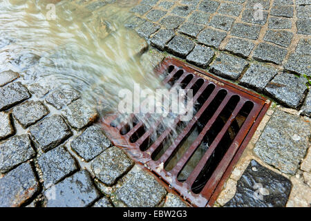 water flowing into a street inlets Stock Photo