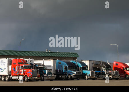 Semi trucks and dark storm clouds at Flying J Travel Plaza, Pasco, WA 99301, United States. truck stop. Stock Photo