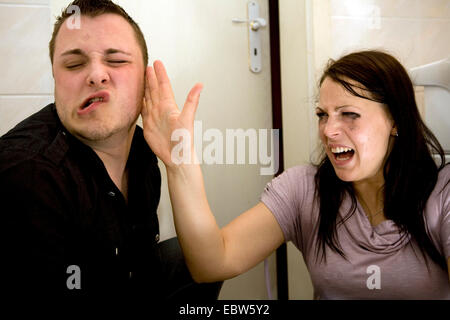 young woman slapping the face of her friend Stock Photo