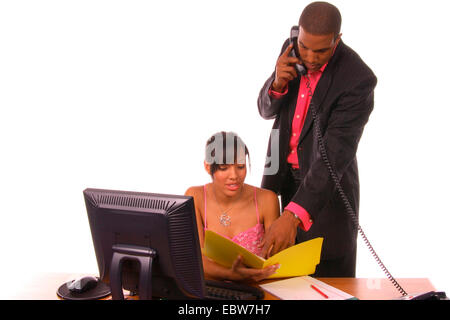 African American executives work as a team to meet a deadline Stock Photo