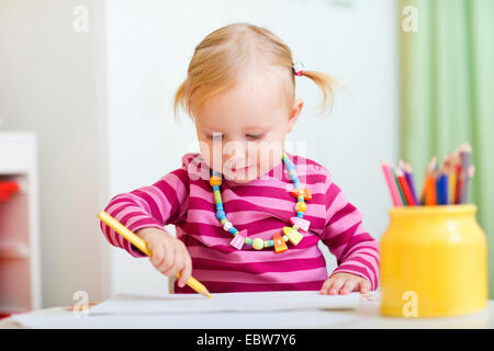 little girl drawing with crayons Stock Photo