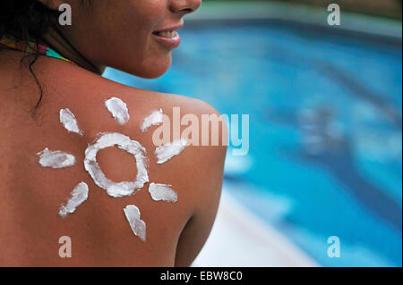 suncream in form of a sun in corner of woman's shoulder Stock Photo
