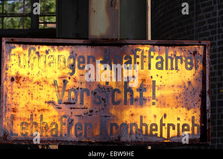old warning sign labeled 'Fussgaenger-Kraftfahrer Vorsicht! Lebhafter Kranbetrieb', Germany, North Rhine-Westphalia, Ruhr Area, Duisburg Stock Photo
