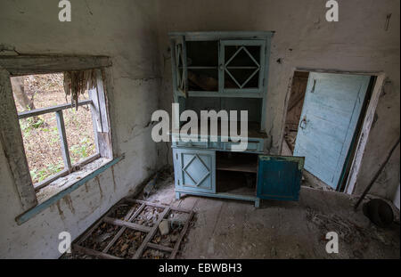 blue wooden cupboard in old wooden cottage in abandoned Stechanka village, Chernobyl Exclusion Zone, Ukraine Stock Photo