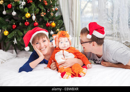 Young family with baby boy dressed in little fox costume Stock Photo