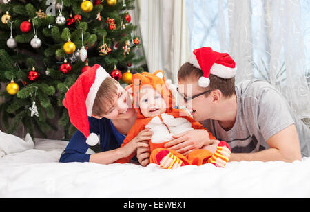 Young family with baby boy dressed in little fox costume Stock Photo
