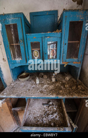 blue cupboard with women pictures in old wooden cottage in abandoned Stechanka village, Chernobyl Exclusion Zone, Ukraine Stock Photo