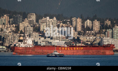 Lower Lonsdale North Vancouver view with SeaBus passenger ferry and anchored freighter 'Darya Jyoti' Burrard Inlet in foreground Stock Photo