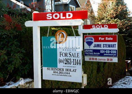 Sold signs outside houses for sale in Vancouver, British Columbia, Canada Stock Photo