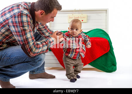 Baby boy with his father on white background Stock Photo