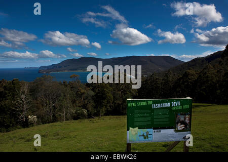 We're Saving the Tasmanian Devil - public information sign at an outlook over Pirate Bay, near Eaglehawk Neck, between the Fores Stock Photo